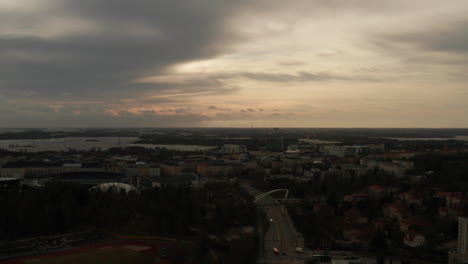 aerial shot a finnish city with a cloudy sky, after sunset time