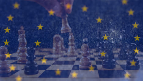 estrellas girando en círculos contra la sección media de la persona jugando al ajedrez