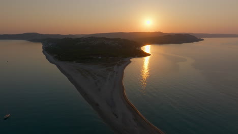 sunset over a beautiful sandy beach and island