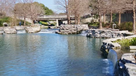 weir of water cascading down river scenic shot of city tourist spot