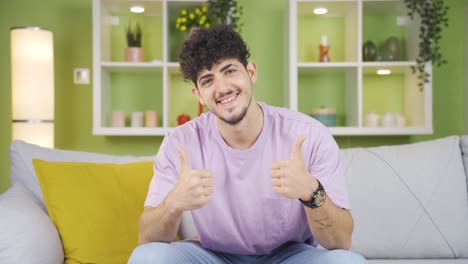 young man looking at camera and making positive gesture.