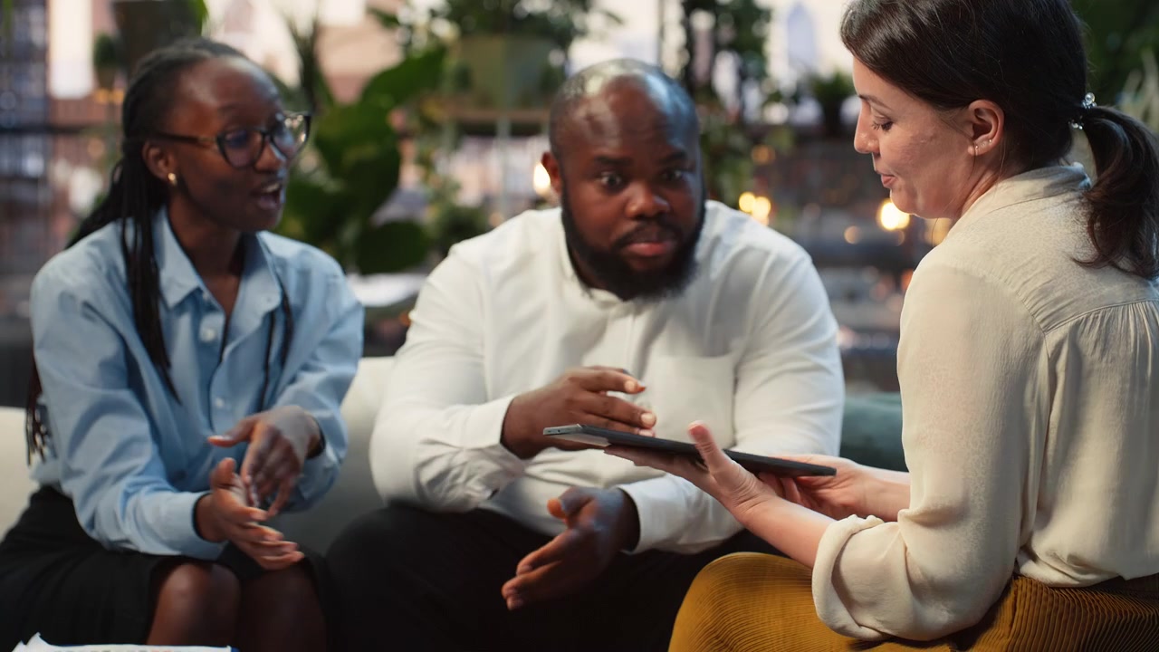 Close up of entrepreneurs assisted by AI model on tablet
