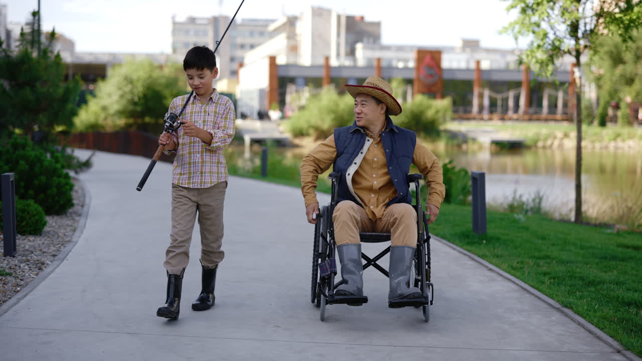 Boy and Man in Wheelchair Fishing Together