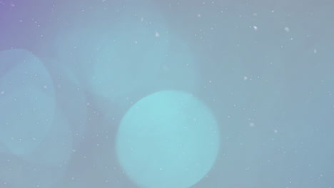 animation of snow over light spots on grey background