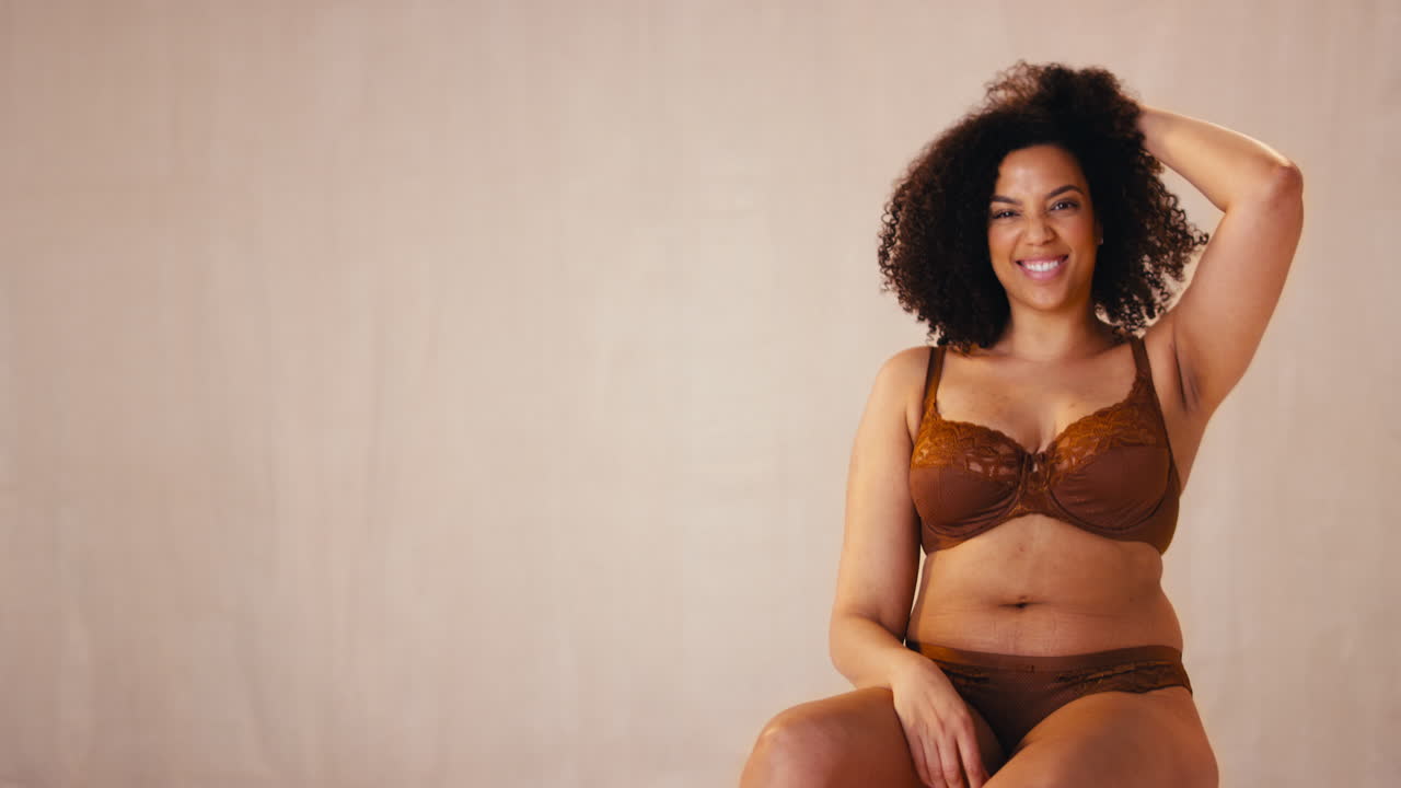 Studio Portrait Shot Of Smiling Confident Natural Woman In Underwear Promoting Body Positivity
