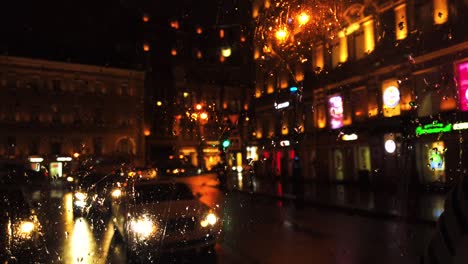 defocused lights in night city street while it's rainnnig