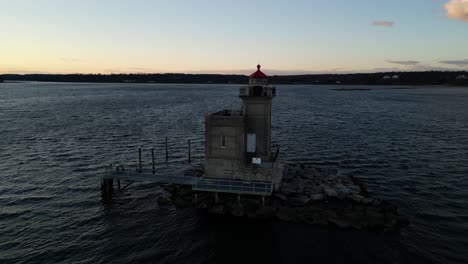 An-aerial-view-of-the-Huntington-Harbor-Lighthouse-on-Long-Island,-NY-at-sunset,-with-a-Christmas-wreath