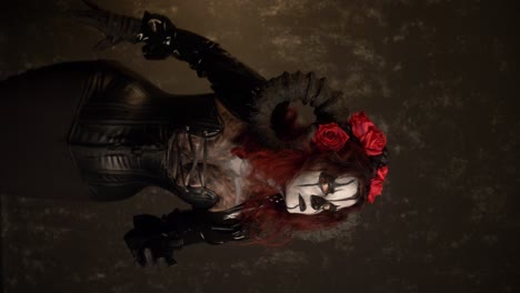 catrina cosplay girl reaching with her hands to the camera with domina outfit and dark background, medium close up
