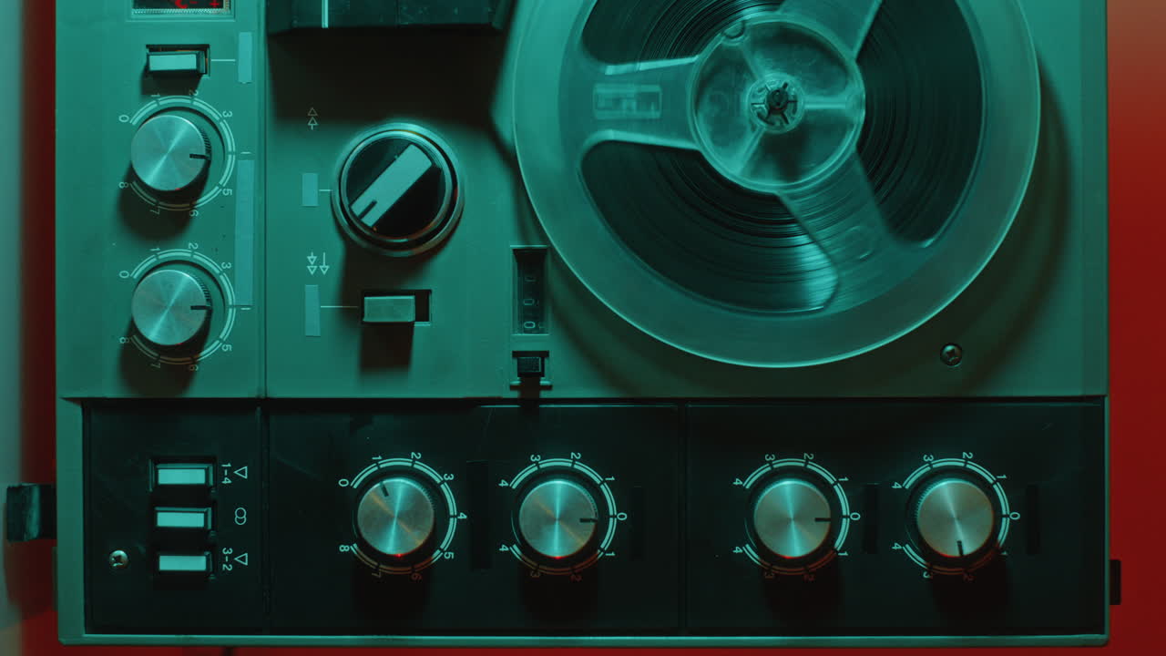Old Fashioned Reel-to-Reel Tape Recorder under Blue Neon Light