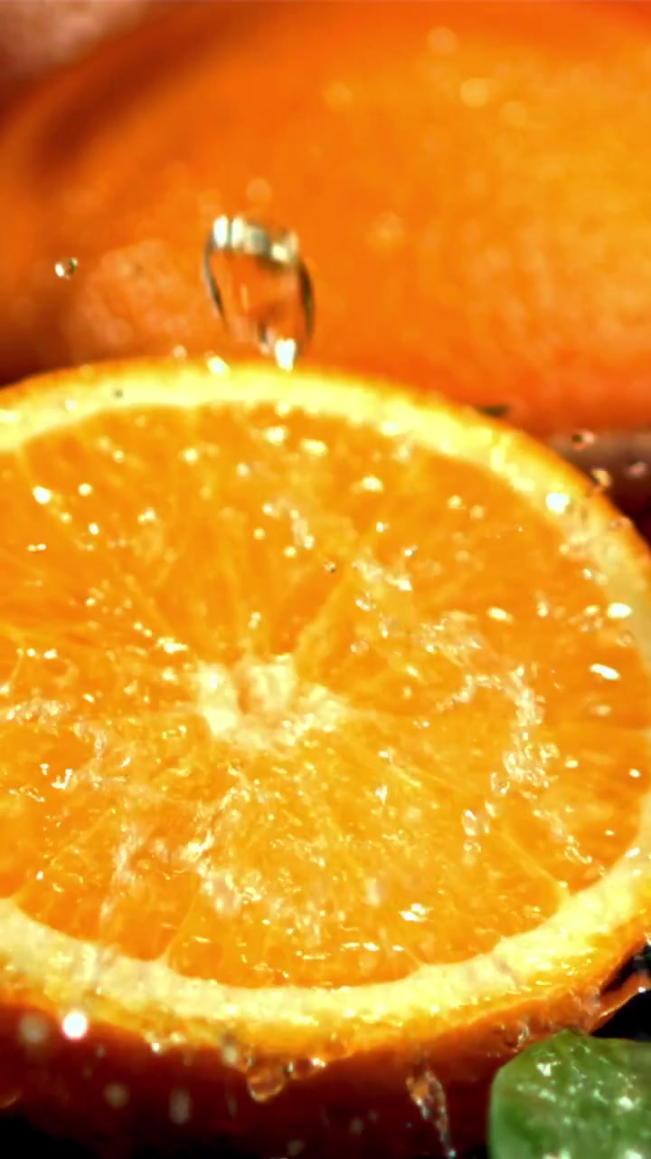 Goccioline d'acqua che schizzano su una fetta d'arancia fresca