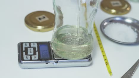 measuring medicinal syrup for dosage - close up slow motion