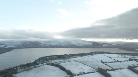 dramatic view of blessington lakes and wicklow mountains during winter on sunset in ireland