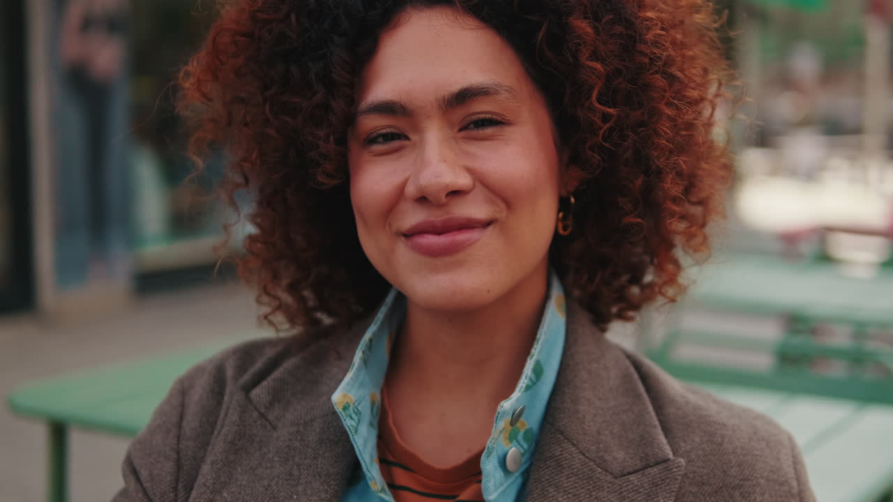 Portrait of Happy Young Woman in City Cafe