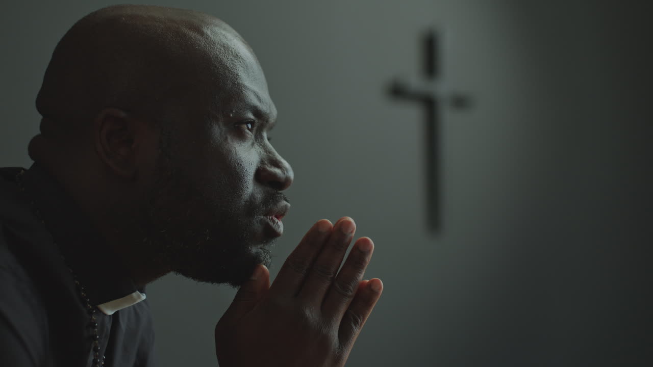 African American Priest Praying to God in Church
