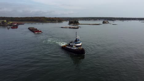 aerial: tugboat pulling cargo