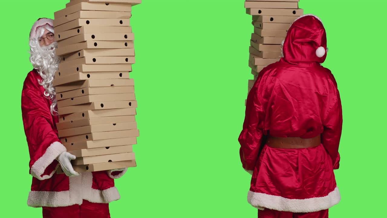 Two Santas carrying stacks of pizza boxes on green screen