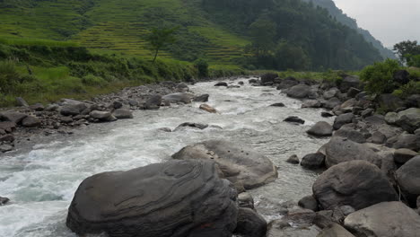 an amazing picturesque mountain landscape with a rushing river in the himalayan mountains of nepal