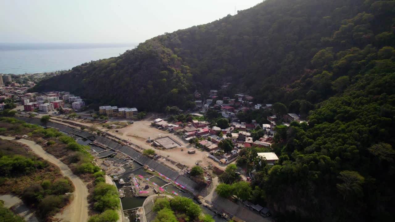 Panoramic aerial view of the coastal village and mountain in Balneario Camuri Grande, La Guaira, Venezuela