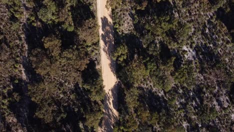 Birds-Eye-View-Above-Two-Dirt-bike-Riders-Racing-Along-Off-Road-Trail