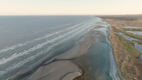 drone shot of an empty beach in the afternoon sun