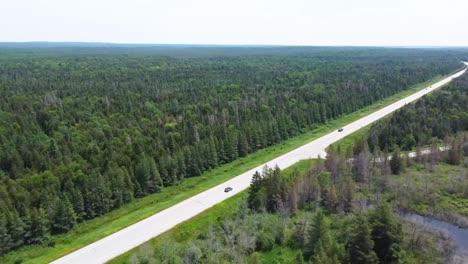 wide aerial follow pinteree road with car