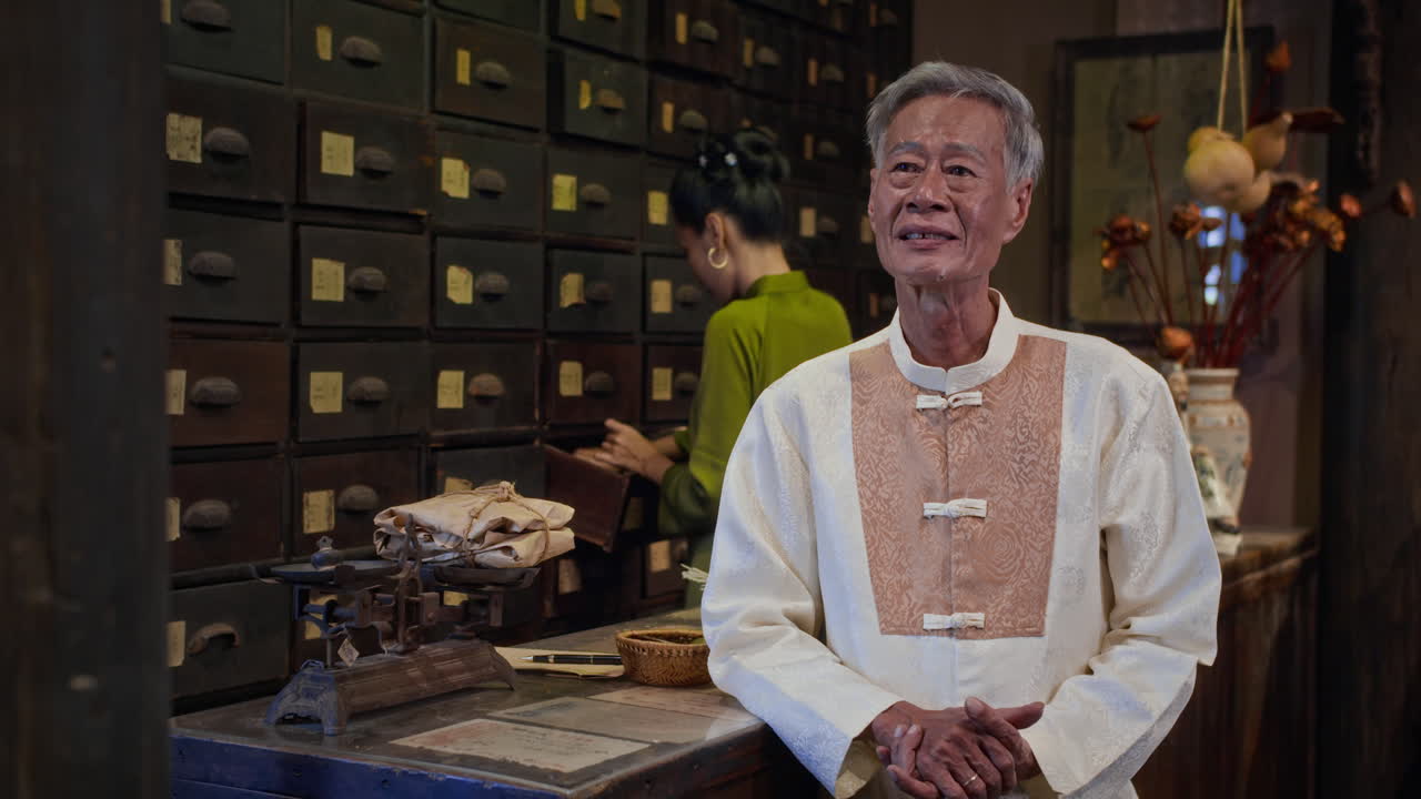 Asian Alternative Medicine Practitioner Smiling at Camera at Pharmacy