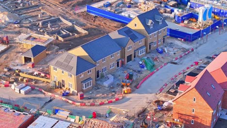 panoramic aerial drone shot panning across a modern housing development under construction, showing new homes, construction equipment, and groundwork in lundhill, wombwell, south yorkshire