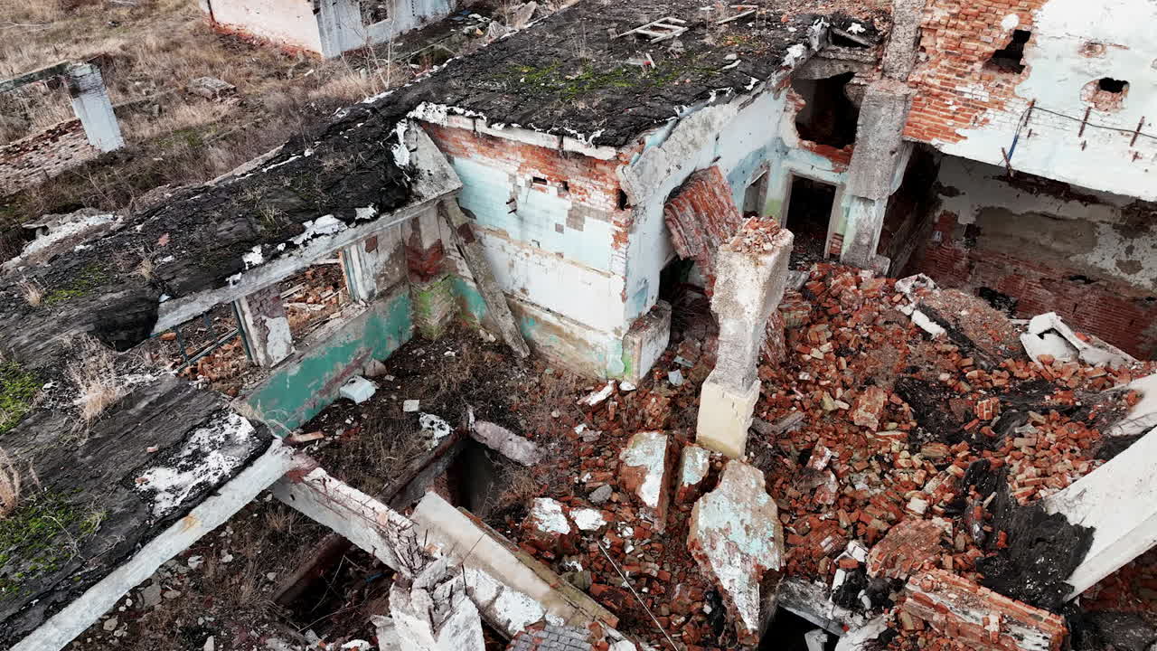 Ruins and wrecks of a destroyed urban territory. Demolished area with buildings into rubble after a natural disaster. Aerial view.