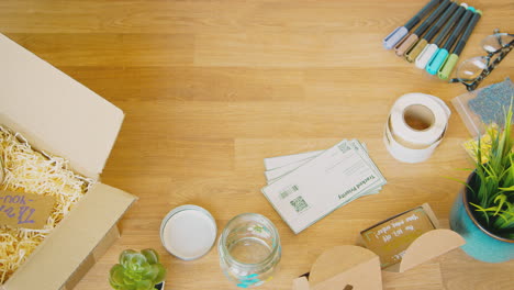 overhead shot of contactless card payment being taken from mobile phone for handmade candles