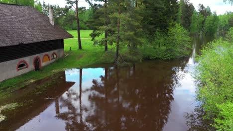 Lakeside-small-village-house-with-beautiful-rooftop,-aerial-pan-view