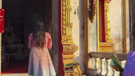 woman praying at a thai temple