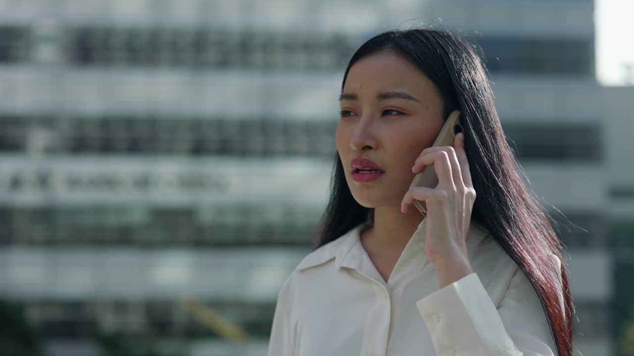 Woman expressing various emotions during a phone call in an urban setting