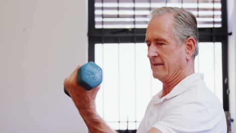 Senior-man-exercising-with-dumbbells-4k