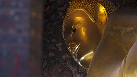 Slow-motion-revealing-shot-of-the-golden-Wat-Pho-Buddha-statue-in-Bangkok