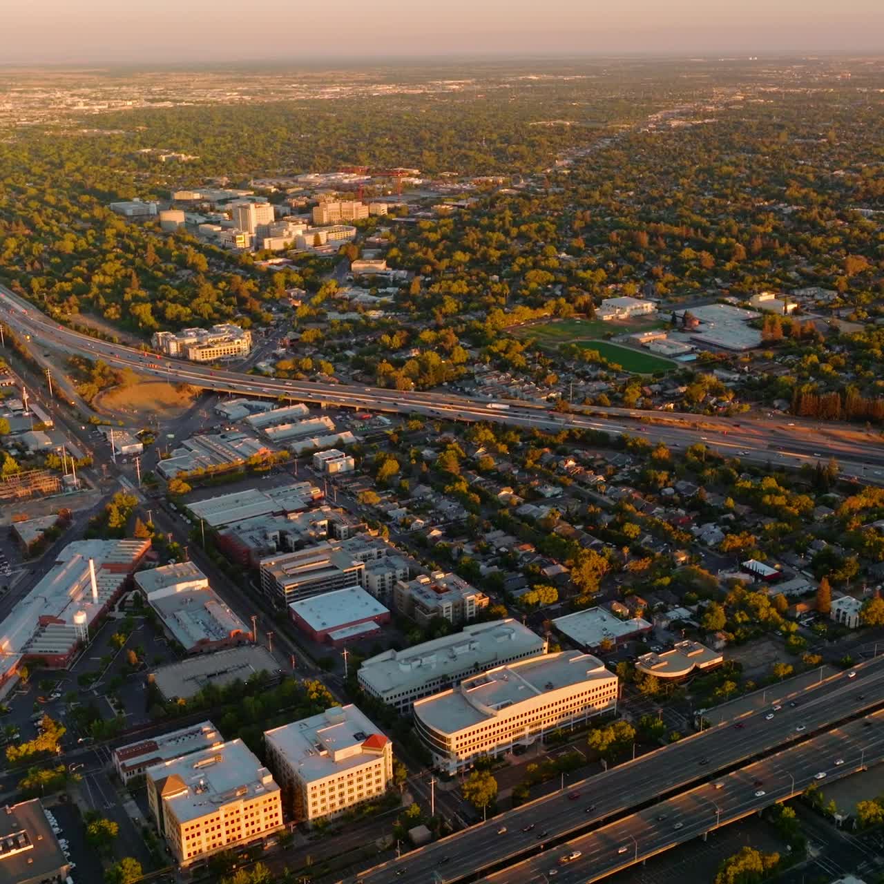 Vast scenery of green beautiful city with wide multi-lane roads. Fine picture of Sacramento, California, USA at sunset