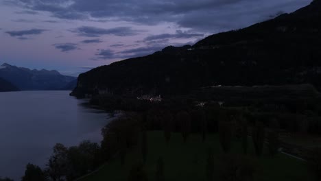 aerial view of the coastal area of lake walensee in switzerland during late evening, capturing the tranquil shoreline and natural beauty as the day transitions into dusk.