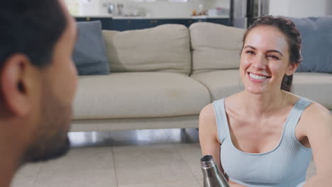 Couple-at-home-chatting-after-exercising-at-home-together---shot-in-slow-motion