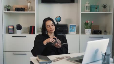 The-woman-is-sitting-at-a-desk-in-an-office