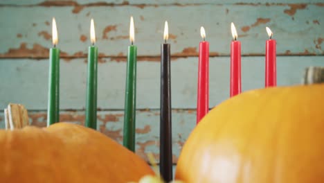 composition of seven lit candles and halloween pumpkins