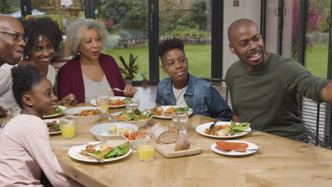 family taking selfie together during family dinner