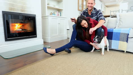 happy couple watching television while playing with pug dog 4k