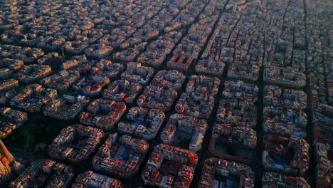 slow tracking aerial over barcelona’s eixample district at dusk with glowing cityscape symmetry