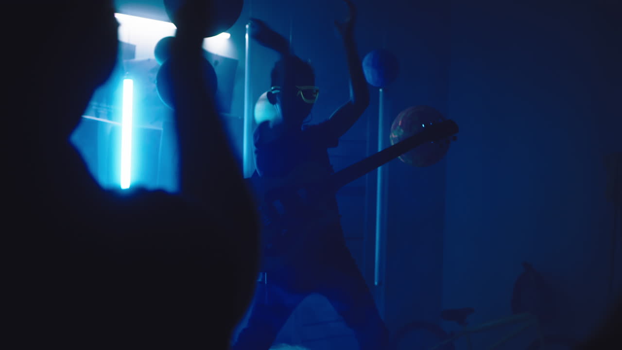 Teenage Boy Performing in a Dark Bedroom