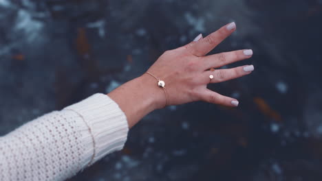 close-up-woman-waving-hand-over-sea-water-on-beach-seaside