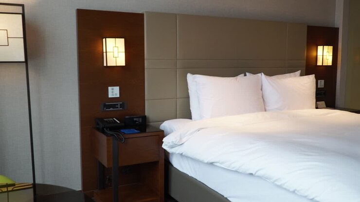 Panning left on made-up king size bed in Bussiness hotel room in Seoul, South Korea