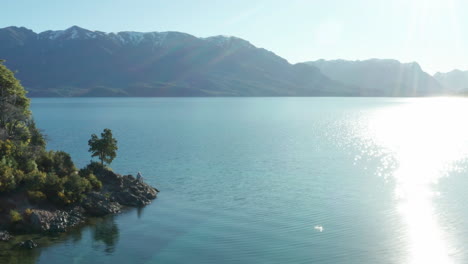 aerial - andes mountains and sunny day on correntoso lake, neuquen, argentina