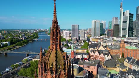 4k aerial drone video of the historic kaiserdom st. bartholomäus church on the banks of the main river in downtown frankfurt, germany