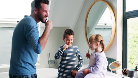 Dad,-children-and-brushing-teeth-in-bathroom