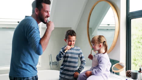 papá, los niños y cepillarse los dientes en el baño