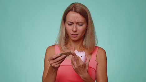 poor woman upset over insufficient amount of money holding piggybank, one dollar banknote bankruptcy